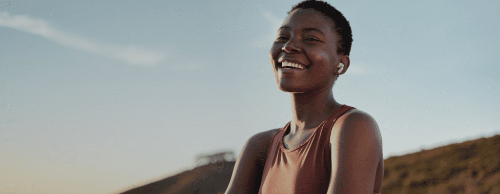 A landscape photo of a young black woman smiling